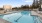 Apartments in Tracy CA - The Vela - Pool Area with Lounge Seating, Covered Cabanas, Hot Tub, and Tree Surroundings