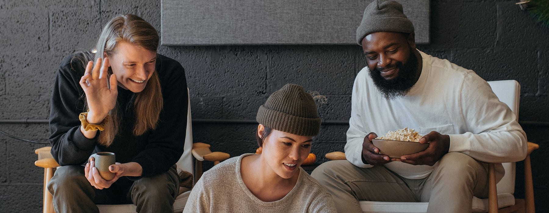 lifestyle image of young friends laughing in a bright indoor envrionment